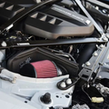 Red performance air intake installed in BMW S58 engine bay - intake installation service for M2, M3, M4 at Bimmer Tech in Los Angeles and Orange County