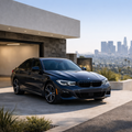 Dark blue BMW 3-Series parked at modern Los Angeles home - BMW Care Plan Smart Driver maintenance package available at Bimmer Tech